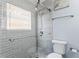 Updated bathroom with gray tile shower and glass door at 19807 Gulf Blvd # 128, Indian Shores, FL 33785