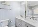 Bathroom with double vanity, marble counters, and walk-in shower at 19807 Gulf Blvd # 128, Indian Shores, FL 33785