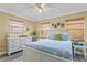 Guest bedroom with white dresser and light blue bedding at 19807 Gulf Blvd # 128, Indian Shores, FL 33785