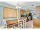 Kitchen and dining area with wood cabinets, table, and chairs at 19807 Gulf Blvd # 128, Indian Shores, FL 33785