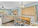 Dining area with wood table and chairs, view of living room at 19807 Gulf Blvd # 128, Indian Shores, FL 33785