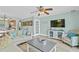 Living room with light walls, wood-look floors, and view of kitchen at 19807 Gulf Blvd # 128, Indian Shores, FL 33785