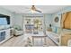 Living room with light walls, wood-look floors, and access to balcony at 19807 Gulf Blvd # 128, Indian Shores, FL 33785