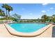 Community pool with ample seating and waterfront views at 19807 Gulf Blvd # 128, Indian Shores, FL 33785