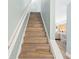 Modern stairs with light wood risers and white railings at 19807 Gulf Blvd # 128, Indian Shores, FL 33785