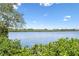 Scenic waterfront view with lush vegetation and blue skies at 19807 Gulf Blvd # 128, Indian Shores, FL 33785