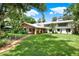 Large house with a well-maintained lawn and landscaping at 20333 Moss Branch Ct, Lutz, FL 33558