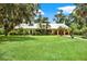 Ranch style home with lush landscaping and a large yard at 20333 Moss Branch Ct, Lutz, FL 33558