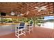 Covered lakefront bar with seating and ceiling fans at 20333 Moss Branch Ct, Lutz, FL 33558