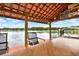 Enjoy the lake view from this covered patio seating area at 20333 Moss Branch Ct, Lutz, FL 33558