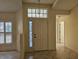 Bright entryway with tile flooring, featuring a double door and a window above at 2421 E Del Webb Blvd, Sun City Center, FL 33573