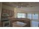 Kitchen with island, wood cabinets, and ample counter space at 2421 E Del Webb Blvd, Sun City Center, FL 33573