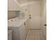 Laundry room with washer, dryer, and exterior access at 2421 E Del Webb Blvd, Sun City Center, FL 33573