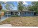 Newly renovated blue house with carport and well-maintained lawn at 3612 W Leila Ave, Tampa, FL 33611
