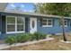 Newly renovated blue house, landscaping, and white trim at 3612 W Leila Ave, Tampa, FL 33611