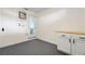 Laundry room with white cabinets and gray floor at 3612 W Leila Ave, Tampa, FL 33611