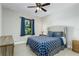 Bright bedroom with a queen-size bed and blue patterned bedding at 4911 Diamonds Palm Loop, Wesley Chapel, FL 33543