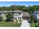 Two-story house with gray siding, brown roof, and landscaping at 4911 Diamonds Palm Loop, Wesley Chapel, FL 33543