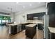 Spacious kitchen featuring granite countertops and dark cabinetry at 4911 Diamonds Palm Loop, Wesley Chapel, FL 33543