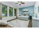 Spacious main bedroom with a light gray bed and accent wall at 4911 Diamonds Palm Loop, Wesley Chapel, FL 33543