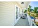 Relaxing balcony with white railing and two wooden chairs at 496 Palm Ave, Palm Harbor, FL 34683