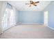 Spacious bedroom with carpet, French doors, and ceiling fan at 496 Palm Ave, Palm Harbor, FL 34683