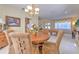 Formal dining room with a charming chandelier and hardwood floors at 5315 Cedarshake Ln, Valrico, FL 33596