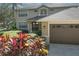 Two-story house with a two-car garage and colorful landscaping at 5315 Cedarshake Ln, Valrico, FL 33596