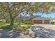 Two-story house with a three-car garage, mature trees, and a large front yard at 5315 Cedarshake Ln, Valrico, FL 33596