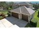 Two-car garage with brown doors attached to a large house at 5315 Cedarshake Ln, Valrico, FL 33596