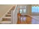 Carpeted staircase with white railing and view of the entryway at 5315 Cedarshake Ln, Valrico, FL 33596