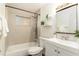 Updated bathroom with a shower/tub combo, white vanity, and new flooring at 6317 S Lansdale Cir, Tampa, FL 33616