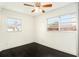 Spacious bedroom with dark hardwood floors and two windows at 6317 S Lansdale Cir, Tampa, FL 33616