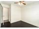 Bright bedroom with dark hardwood floors and access to hallway at 6317 S Lansdale Cir, Tampa, FL 33616