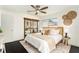 Bedroom with king-size bed, mirrored closet doors, and ceiling fan at 6317 S Lansdale Cir, Tampa, FL 33616