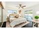 Main bedroom with pool view, king-size bed, and dark hardwood floors at 6317 S Lansdale Cir, Tampa, FL 33616