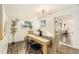 Light-filled dining room featuring a rustic wooden table at 6317 S Lansdale Cir, Tampa, FL 33616