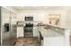 Modern kitchen featuring stainless steel appliances and granite countertops at 6317 S Lansdale Cir, Tampa, FL 33616