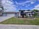 Beautiful two-story home with a three-car garage and landscaped yard at 9359 Wellington Park Cir, Tampa, FL 33647