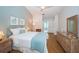 Spacious bedroom with light blue walls, a queen bed, and ensuite bathroom access at 943 Lucas Ln, Oldsmar, FL 34677