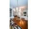 Bright dining room featuring a large wooden table and modern chandelier at 943 Lucas Ln, Oldsmar, FL 34677