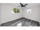 Well-lit bedroom with ceiling fan and gray flooring at 10214 66Th Ave, Seminole, FL 33772