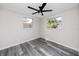 Bright bedroom with two windows and gray flooring at 10214 66Th Ave, Seminole, FL 33772