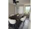 Dining room featuring a dark wood table, neutral chairs, and a plant at 10214 66Th Ave, Seminole, FL 33772