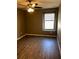 Simple bedroom with ceiling fan and large window at 11539 Gallatin Trl, Parrish, FL 34219