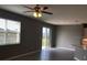 Bright living room with sliding glass doors and ceiling fan at 11539 Gallatin Trl, Parrish, FL 34219