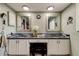 Double vanity bathroom with granite countertops and white cabinets at 390 Cypress Creek Cir, Oldsmar, FL 34677