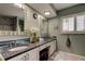 Double vanity bathroom with granite countertops and large mirrors at 390 Cypress Creek Cir, Oldsmar, FL 34677