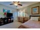 Bedroom with TV, built-in shelving and ceiling fan at 390 Cypress Creek Cir, Oldsmar, FL 34677