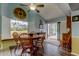 Bright dining area with wood table and chairs, and view of golf course at 390 Cypress Creek Cir, Oldsmar, FL 34677